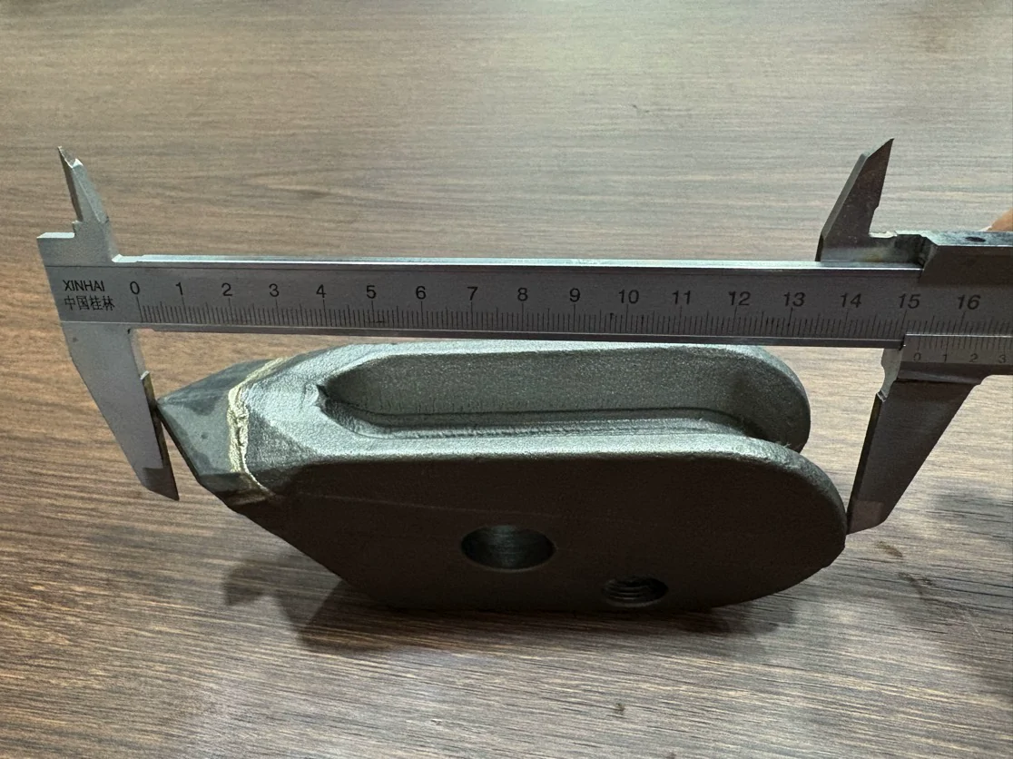 Caliper positioned across the overall length of a JM cutter-tooth sample