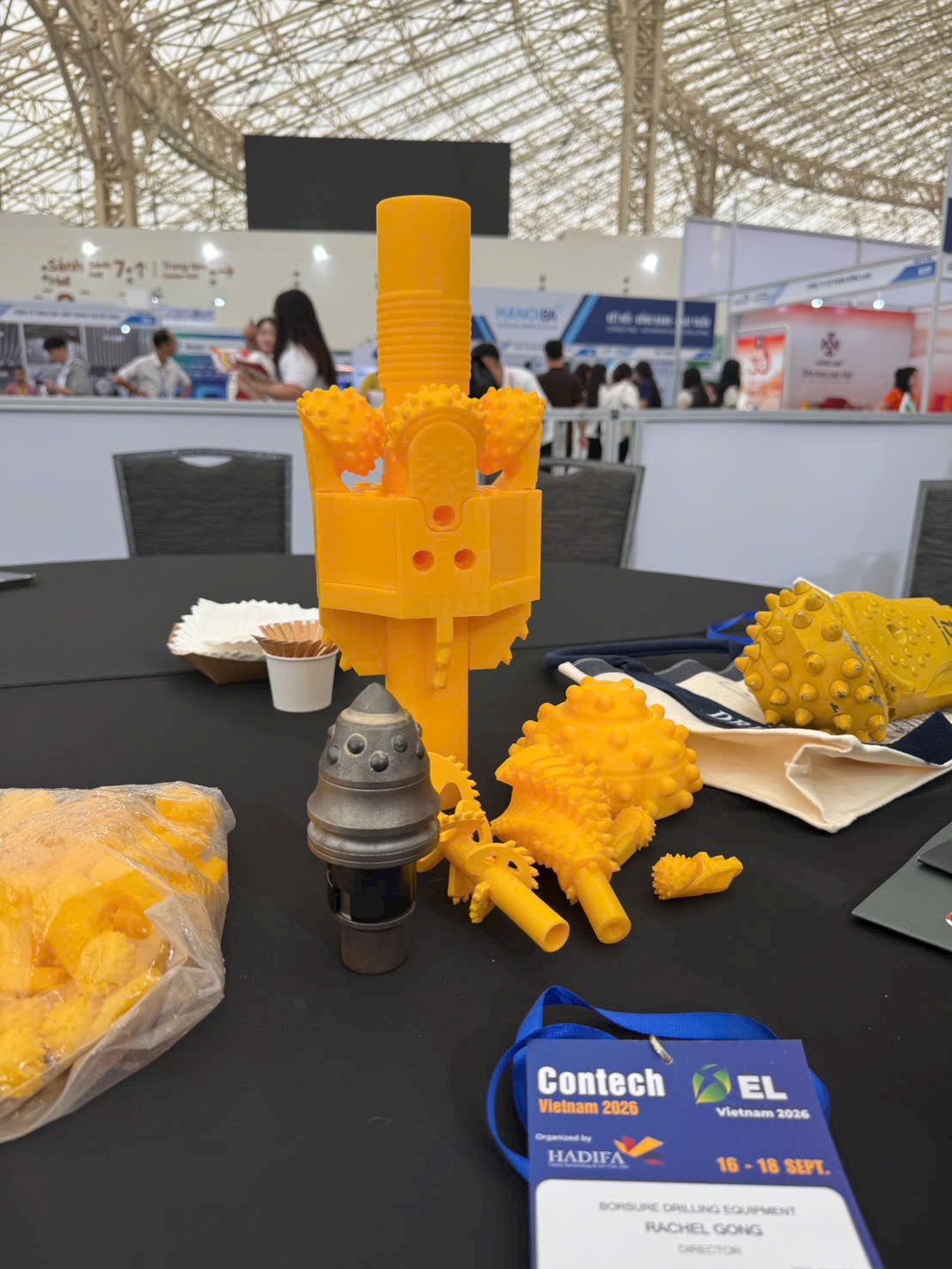 Drilling-tool models and cutter samples at the event. The yellow models illustrate tool geometry; the display includes scale models as well as physical cutter samples.