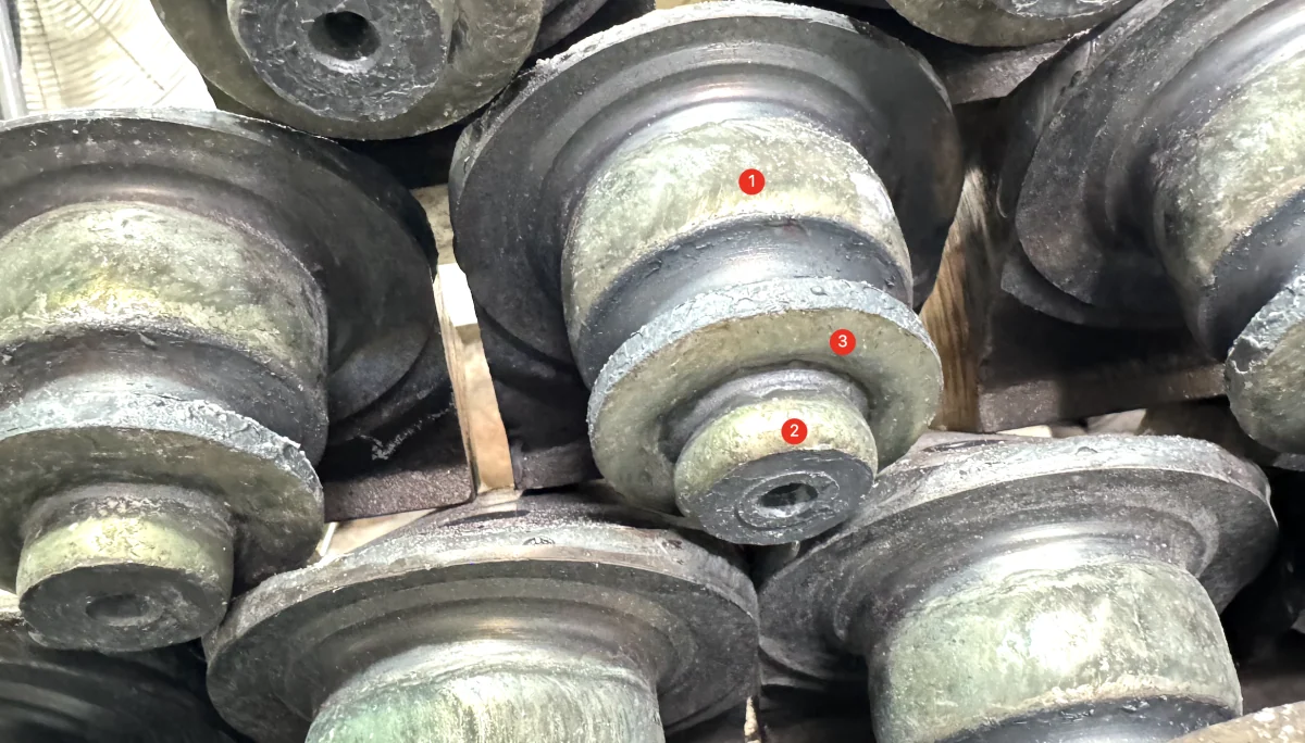 Roller-bit journals after hardfacing, before machining; original numbered marks retained.