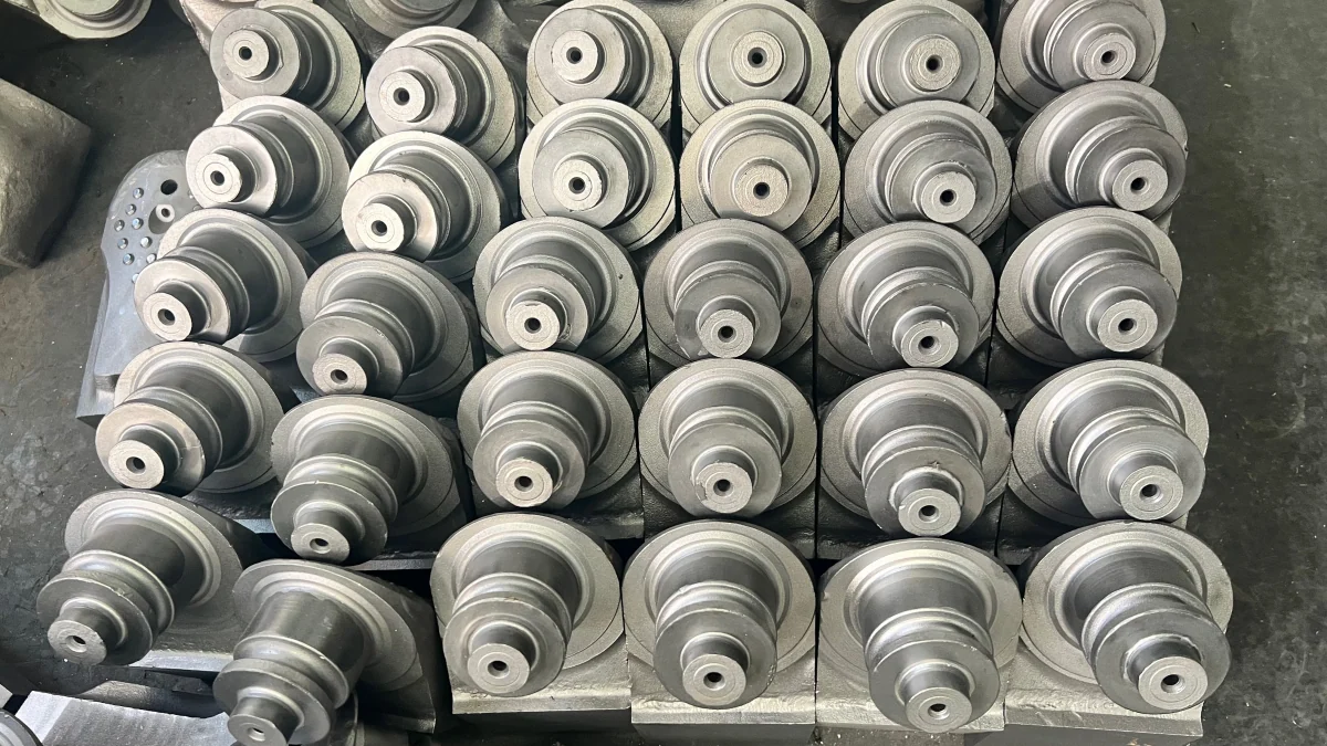 A group of roller-bit legs with machined journals.